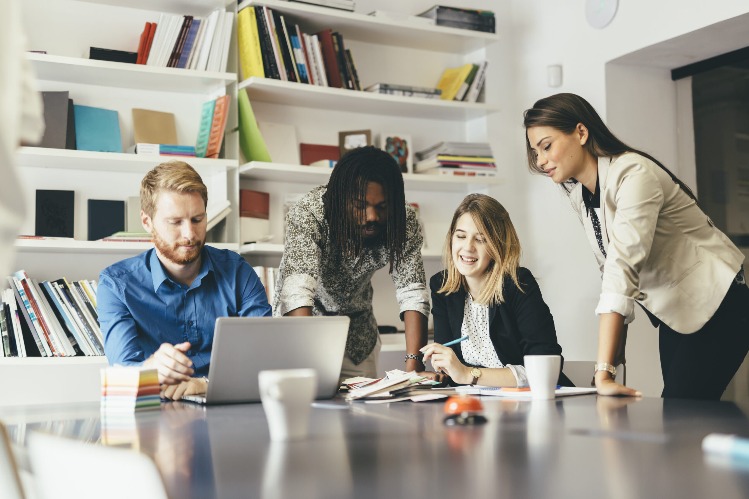 Brainstorming colleagues sitting at office desk and sharing ideas